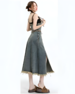 Woman wearing the autumn set, a denim dress with a distressed hem.