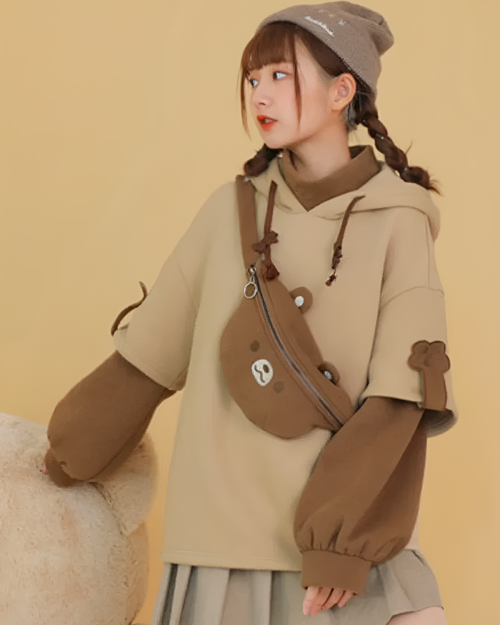 The Bearcore hoodie featuring a brown bear backpack and plush bear accents.