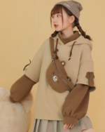 The Bearcore hoodie featuring a brown bear backpack and plush bear accents.