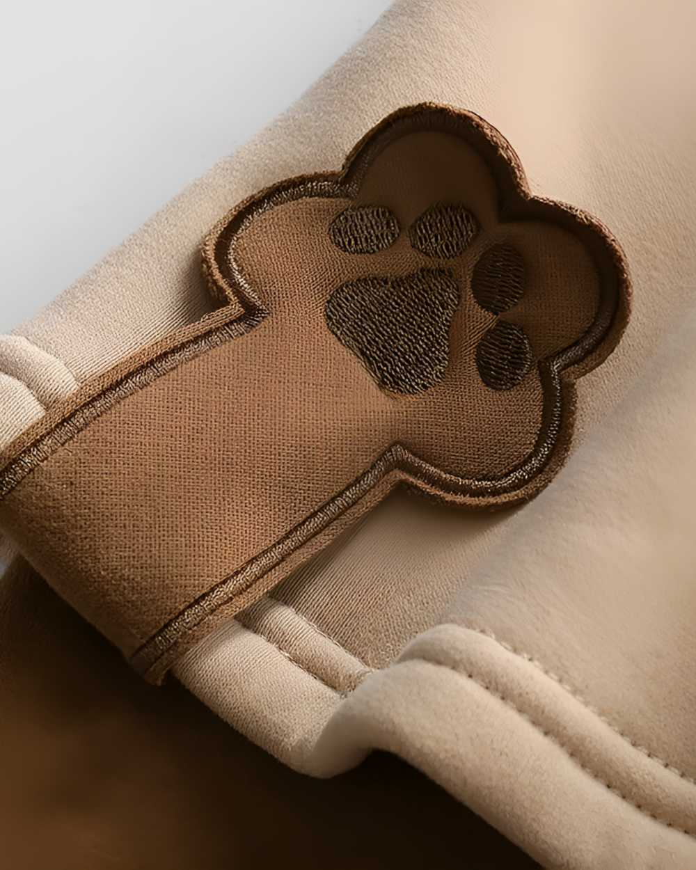 Close-up of a Bearcore hoodie, featuring an embroidered paw print detail on the sleeve.