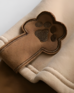 Close-up of a Bearcore hoodie, featuring an embroidered paw print detail on the sleeve.