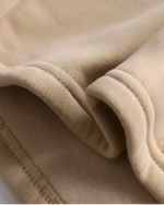 Close-up of a beige Bearcore hoodie, showcasing soft fabric texture and stitching.