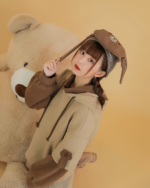 Model wearing The Bearcore hoodie with a plush bear and bunny ear hat.