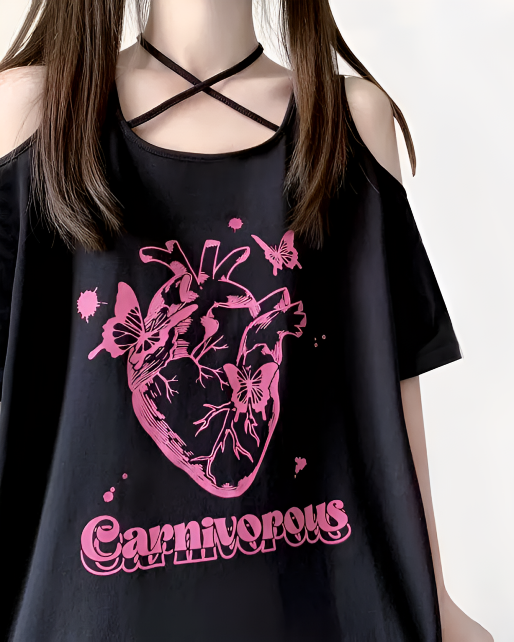 Black gothic oversized tee featuring a detailed heart graphic with butterflies and the text "Carnivorous".