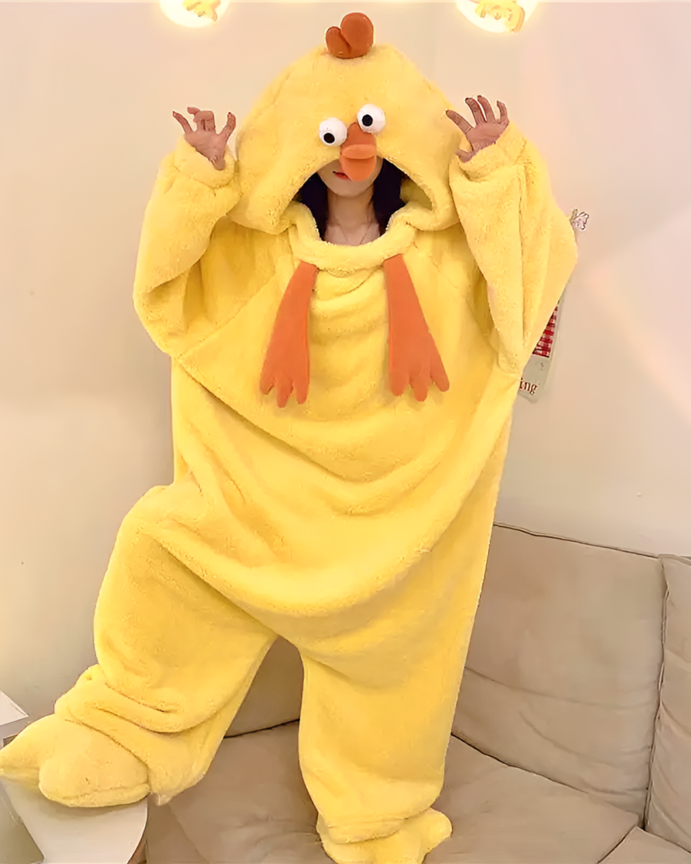 Person wearing a yellow Chicken Kigurumi with a hood and orange feet. A cozy and fun costume.