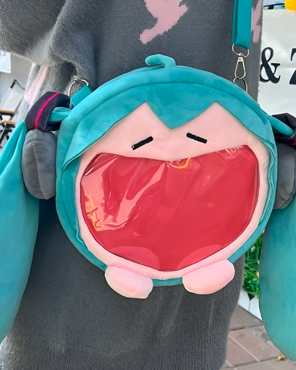 The Incredible Miku Plush Bag features a plush Miku head with a clear window pocket and carrying strap.