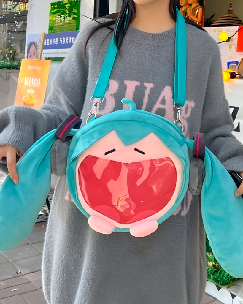 The Incredible Miku plush bag, a teal crossbody bag with a Miku plush attachment.
