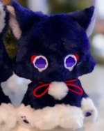 Close-up of The Scarameow Plushie, a dark blue and white Scarameow plushie with red eyes and a red ribbon.