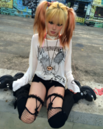 A person wearing a white Transluscent Nothingness T-Shirt while roller skating. The shirt has a graphic print.