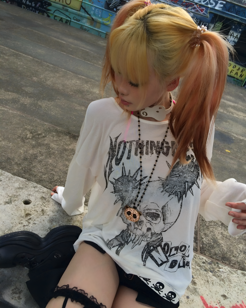 Person wearing a white Transluscent Nothingness T-Shirt with a graphic design. Casual streetwear style.