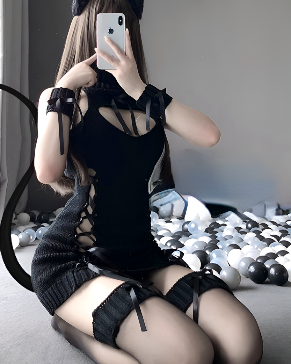 Woman wearing a black "turtleneck virgin killer" lingerie set with cutouts and thigh-highs. Includes gloves and a headpiece.