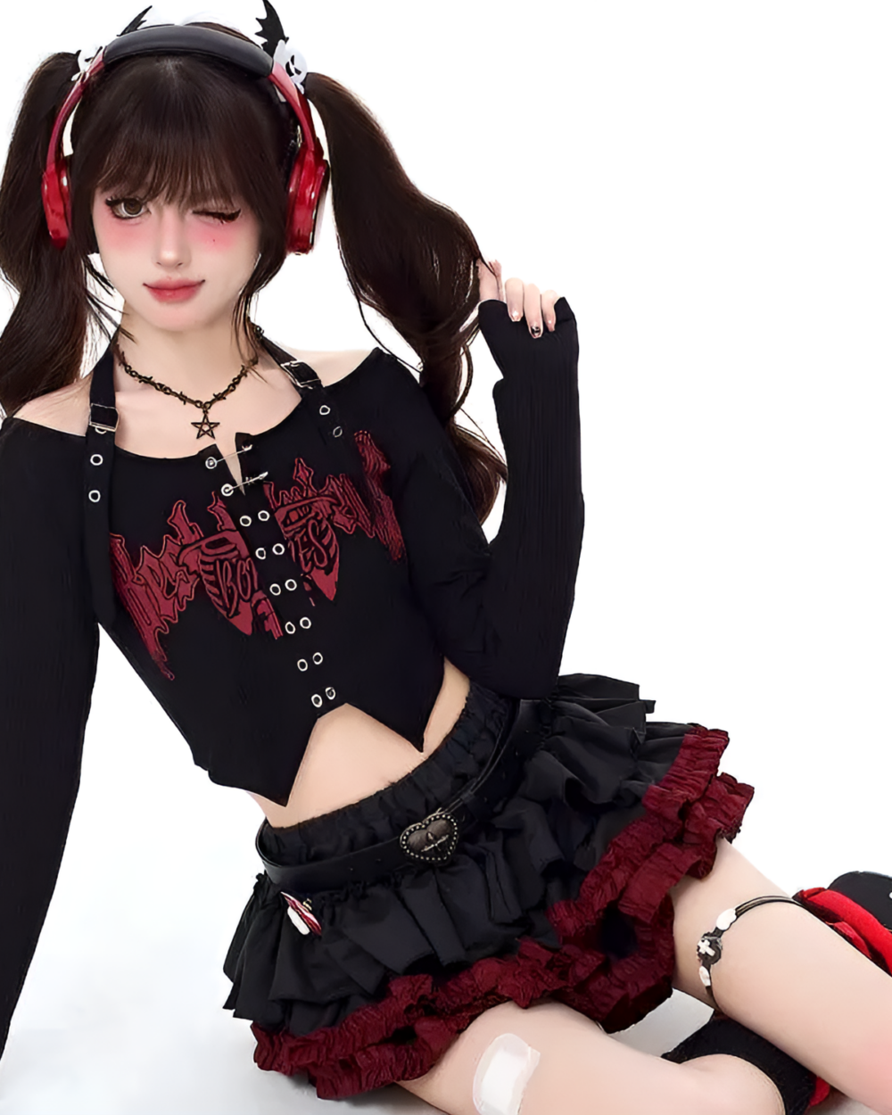 Model wearing the Venom Heart Ruffle Skirt set, a black mini skirt with red ruffle details and a matching long-sleeve crop top.