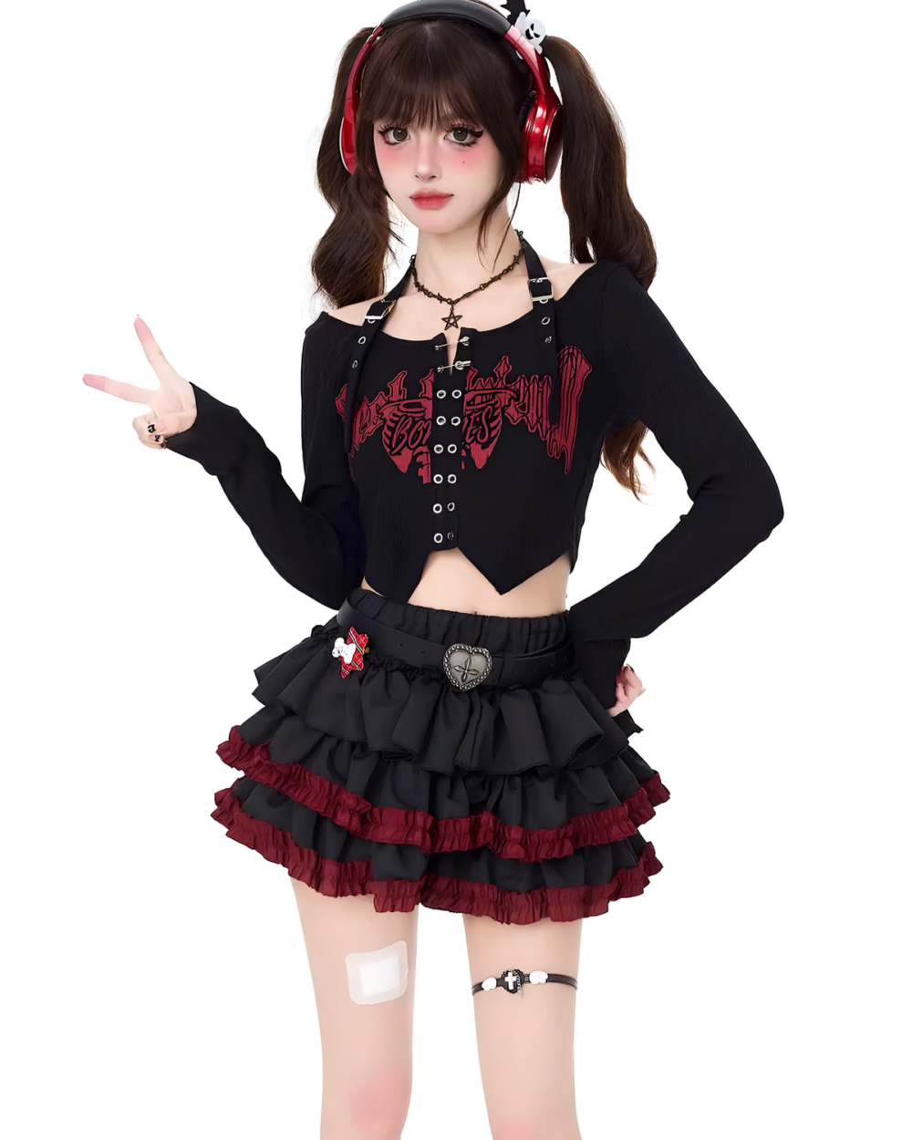 Model wearing a black Venom Heart Ruffle Skirt set with a heart graphic and ruffle details.