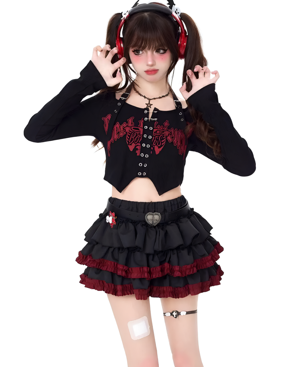 Model wearing the Venom Heart Ruffle Skirt set, a black mini skirt with red ruffle detailing and matching long sleeve top.