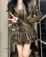 Brown vintage pleated dress suit with a belted skirt, displayed on a mannequin.