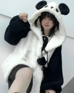 Woman wearing a Winter Hooded Coat - Panda Edition, a fluffy black and white panda fleece hoodie. The coat has panda ears on the hood.