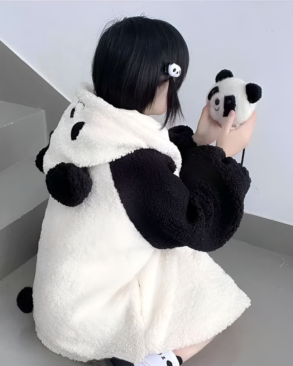 Woman wearing a Winter Hooded Coat - Panda Edition, a fluffy panda fleece hoodie with a cute panda design.