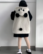 Back view of a person wearing a white and black panda fleece hoodie, the Winter Hooded Coat - Panda Edition.