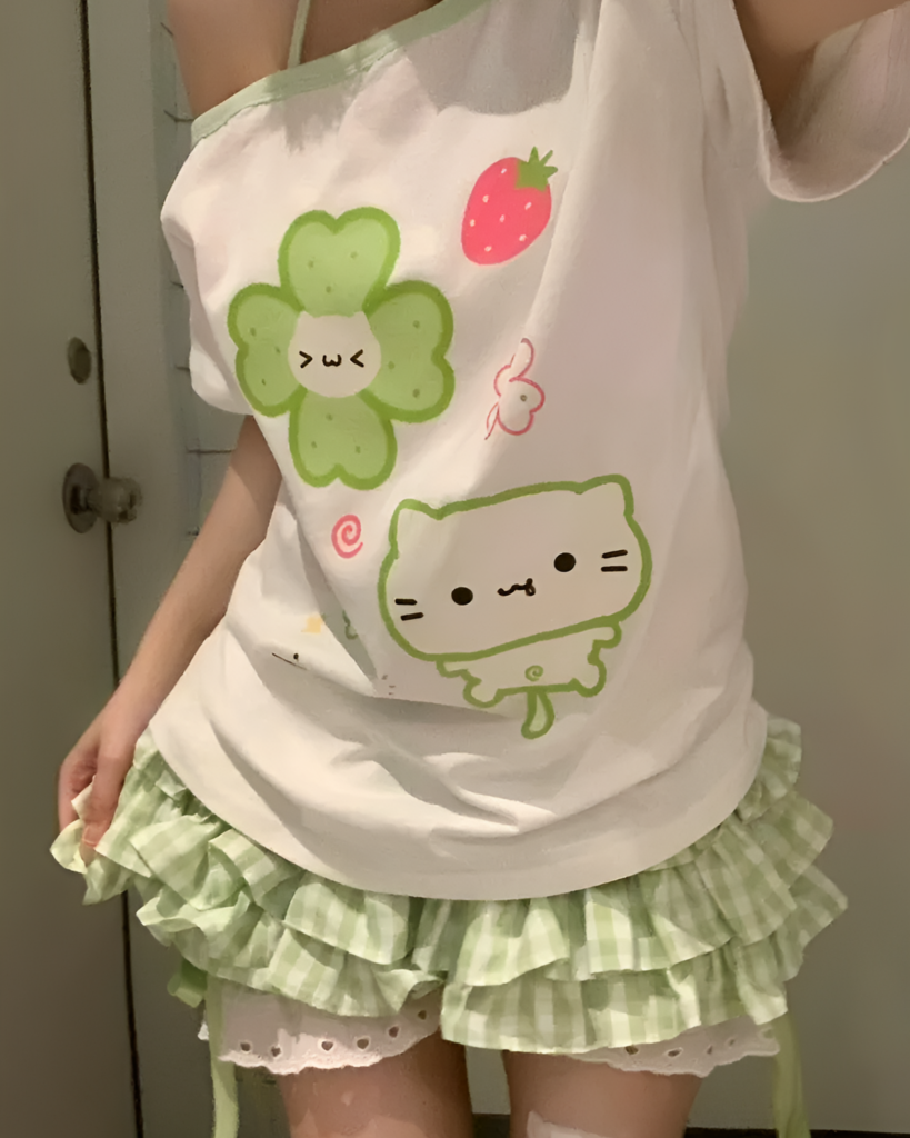 Yotsuba Neko T-Shirts featuring a cat graphic with strawberry and floral details.