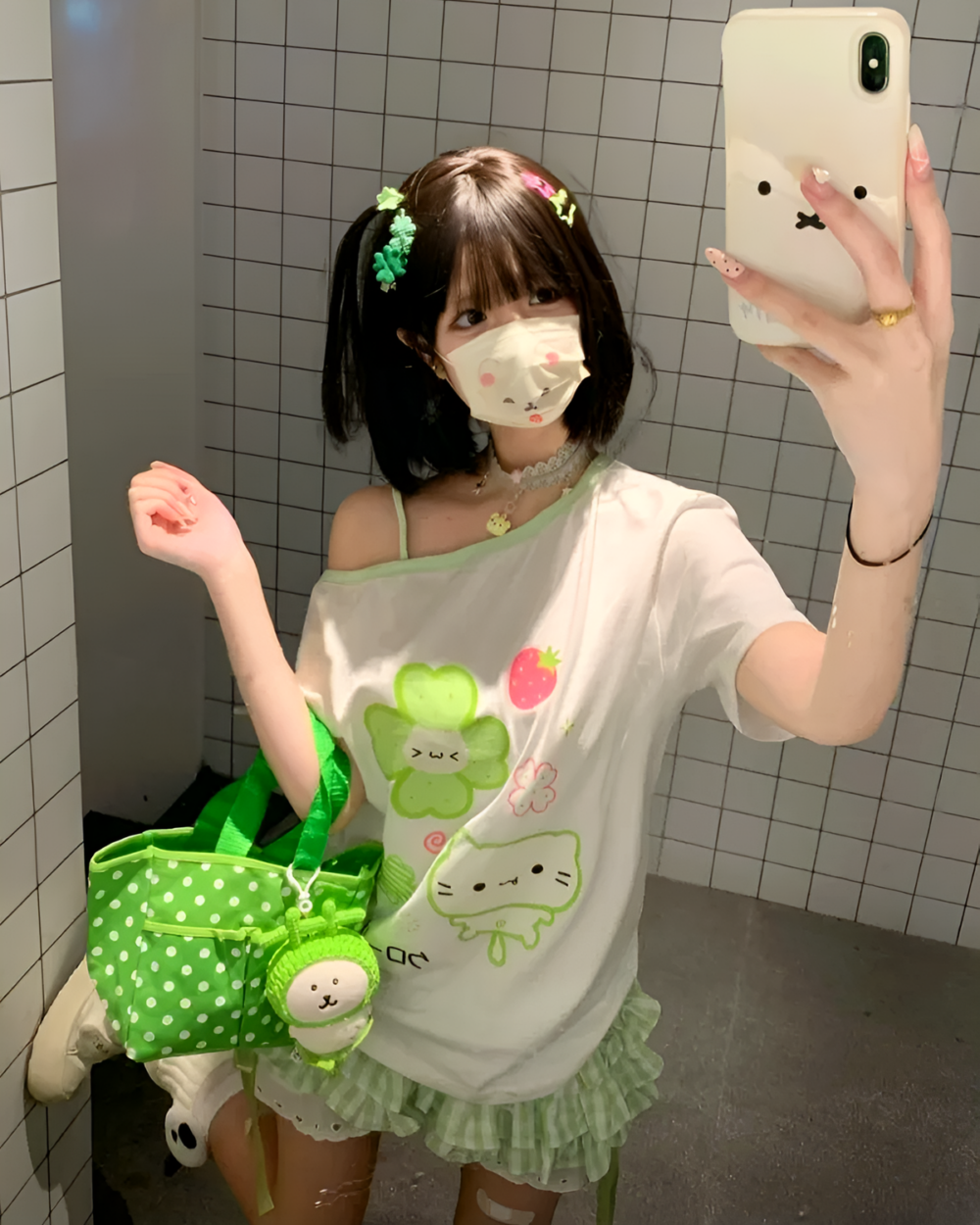Person wearing Yotsuba Neko T-Shirts, mask, and accessories in a restroom.