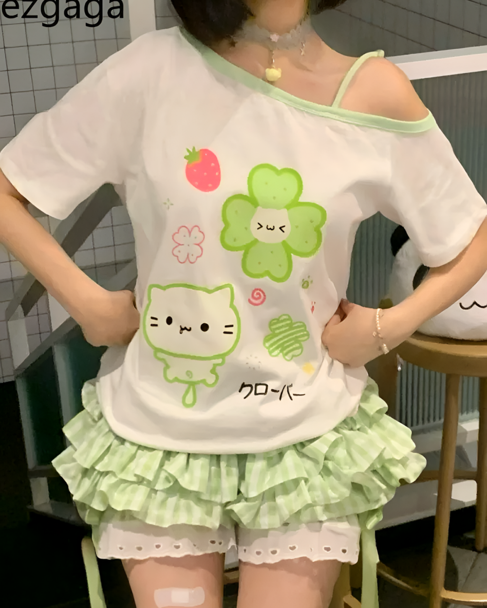 Yotsuba Neko T-Shirts featuring kawaii cat and strawberry design on a pastel green skirt set.