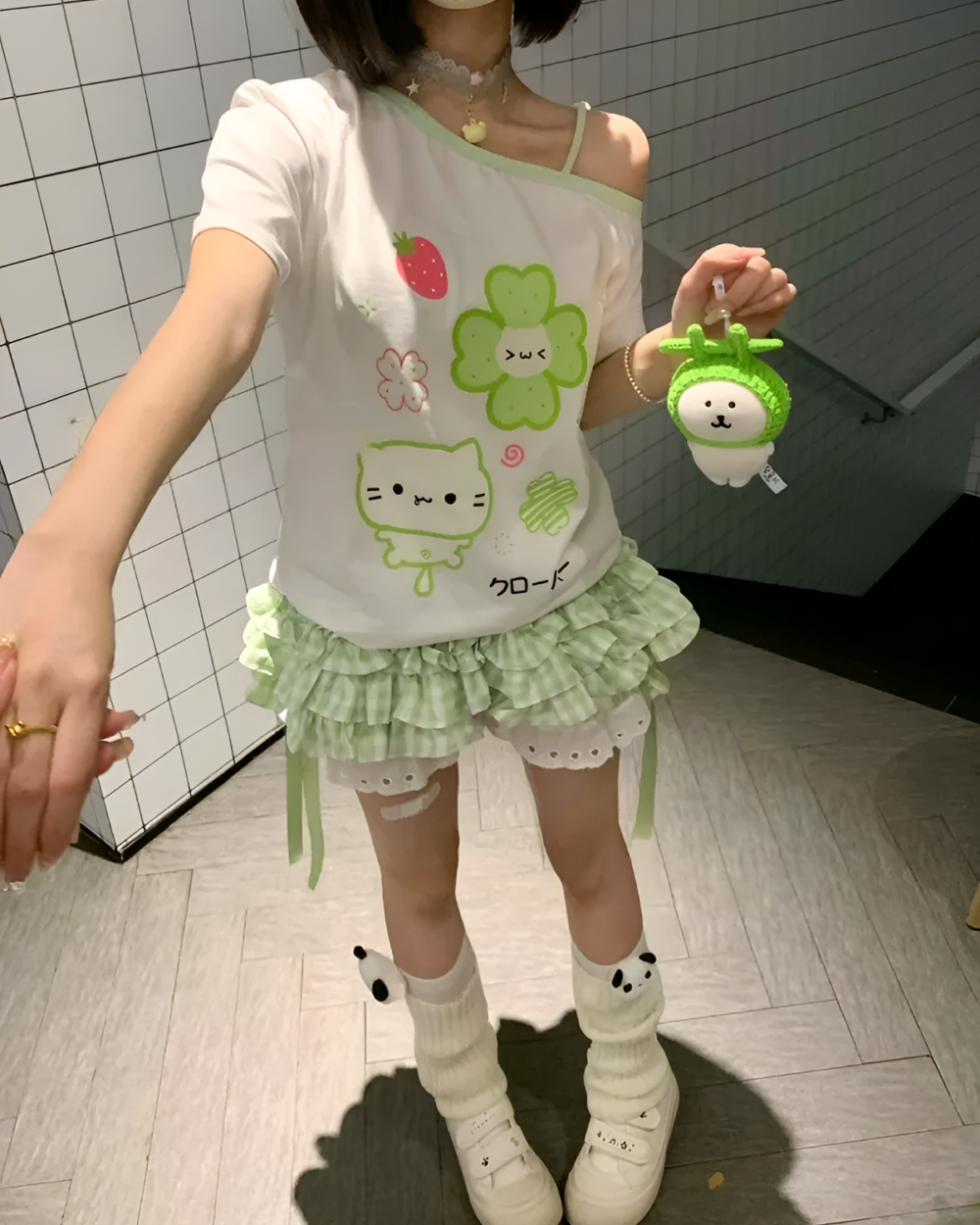 Person wearing Yotsuba Neko T-Shirts with green skirt and accessories.