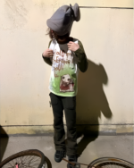 I Told My Therapist shirt worn by a person on a bicycle, featuring a graphic design.