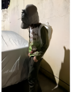 Model wearing a I Told My Therapist shirt, pants, and hat.