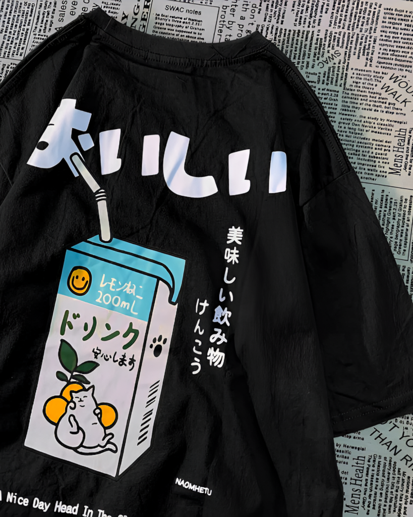 Black t-shirt with a kawaii cat shirt design featuring a milk carton and Japanese text. "おいしい" is written on the shirt.