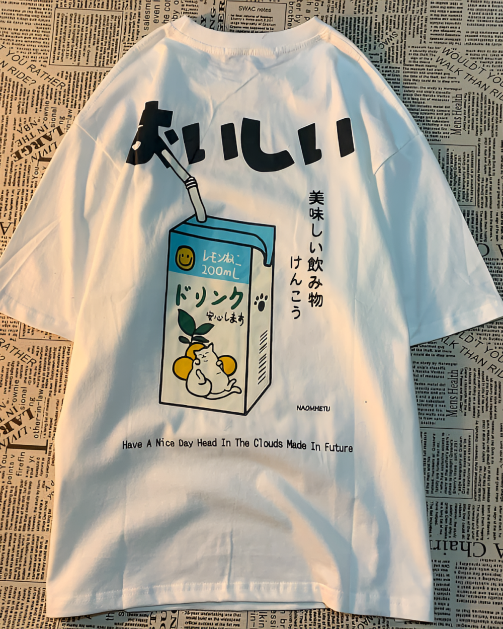 White oversized t-shirt with a kawaii cat shirt design featuring a milk carton and Japanese text. "おいしい" T-Shirt.